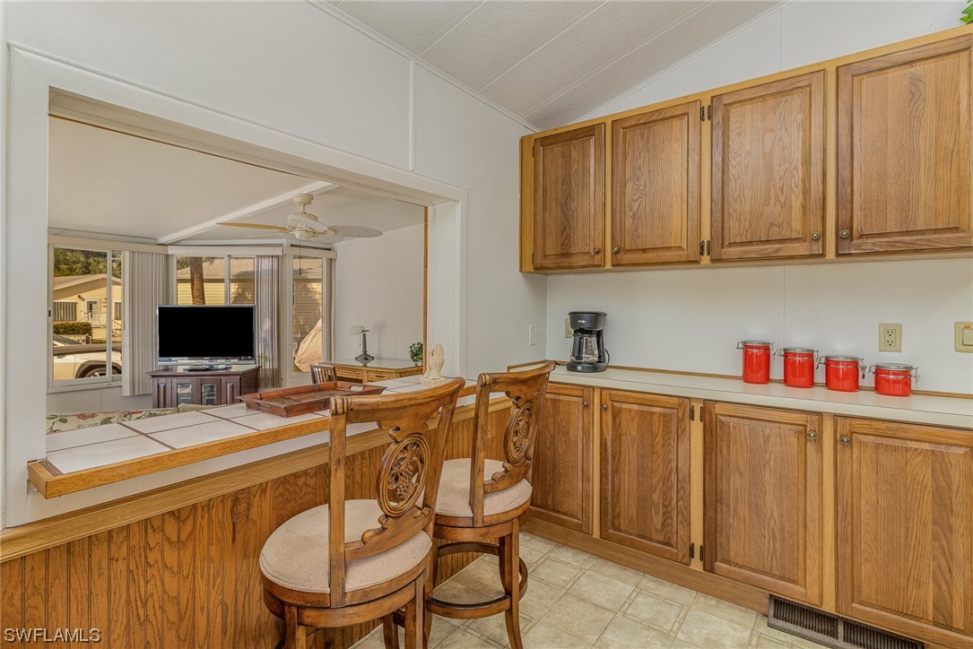 10844 Ani Circle Estero, FL 33928 - Photo 7 of 24 a room with stainless steel appliances a sink dishwasher stove and microwave with wooden floor