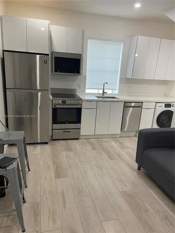 a kitchen with a refrigerator and a sink