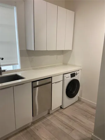 a kitchen with a sink a stove and cabinets