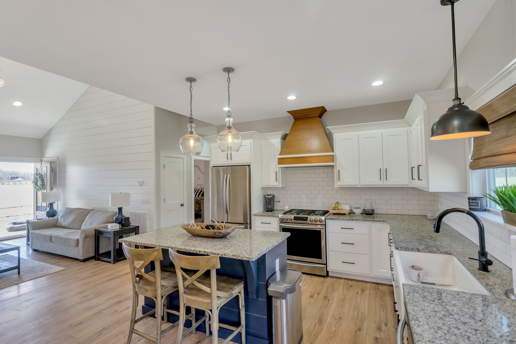 1687 Porter Road Burns, TN 37029 - Photo 8 of 32 a kitchen with stainless steel appliances a dining table chairs stove and white cabinets