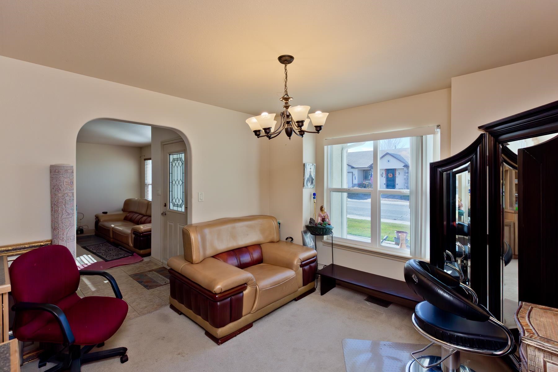 236 Frontier Street Grand Junction, CO 81503 - Photo 15 of 40 a living room with furniture a window and a chandelier