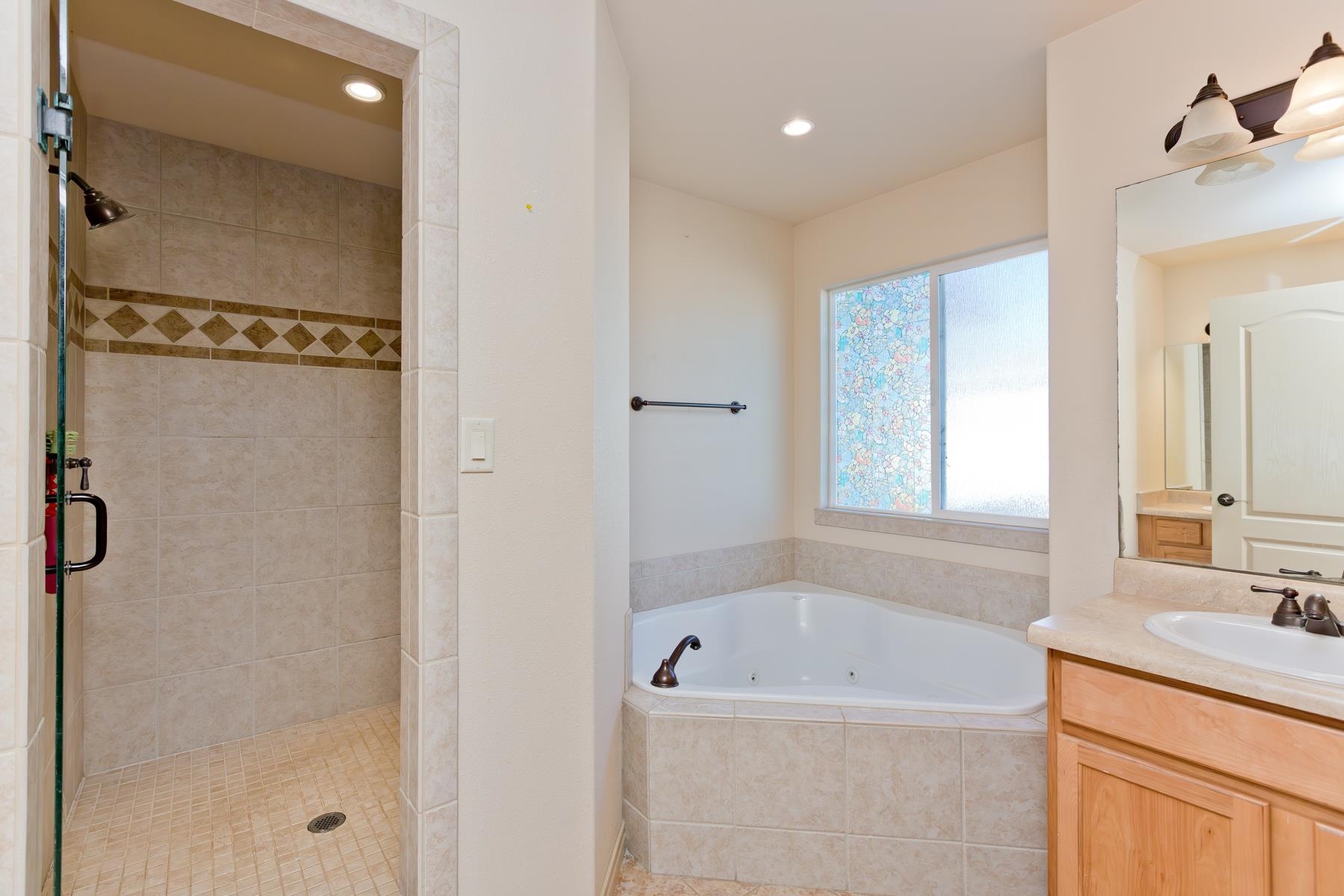 236 Frontier Street Grand Junction, CO 81503 - Photo 32 of 40 a bathroom with a tub sink and mirror