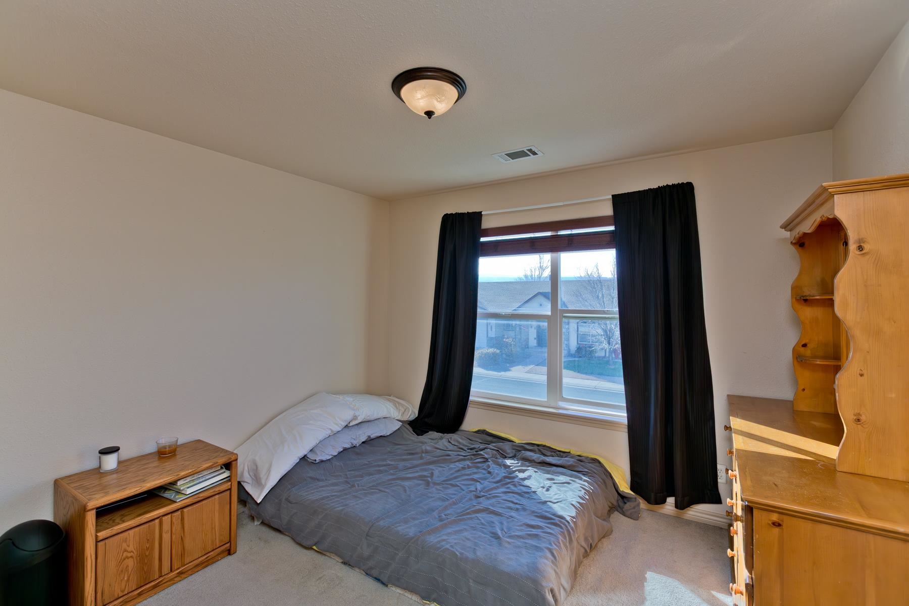 236 Frontier Street Grand Junction, CO 81503 - Photo 38 of 40 a bedroom with a bed and wooden floor