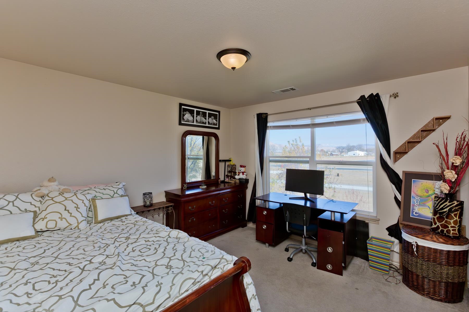 236 Frontier Street Grand Junction, CO 81503 - Photo 40 of 40 a bedroom with a bed and a flat screen tv