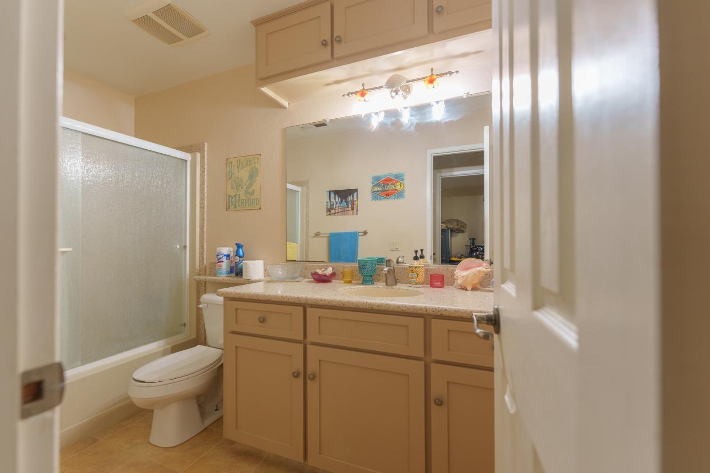 19308 Creekside Circle Salinas, CA 93908 - Photo 15 of 21 a bathroom with a toilet a sink and mirror