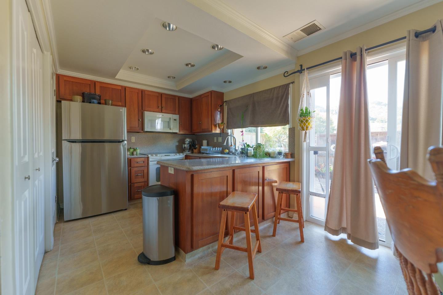 19308 Creekside Circle Salinas, CA 93908 - Photo 7 of 21 a kitchen with stainless steel appliances granite countertop a refrigerator and a stove top oven