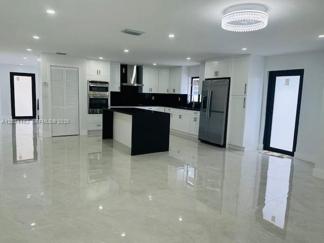 11870 Southwest 5th Street, Unit 1 Miami, FL 33184 - Photo 12 of 38 a large kitchen with stainless steel appliances a refrigerator and a sink