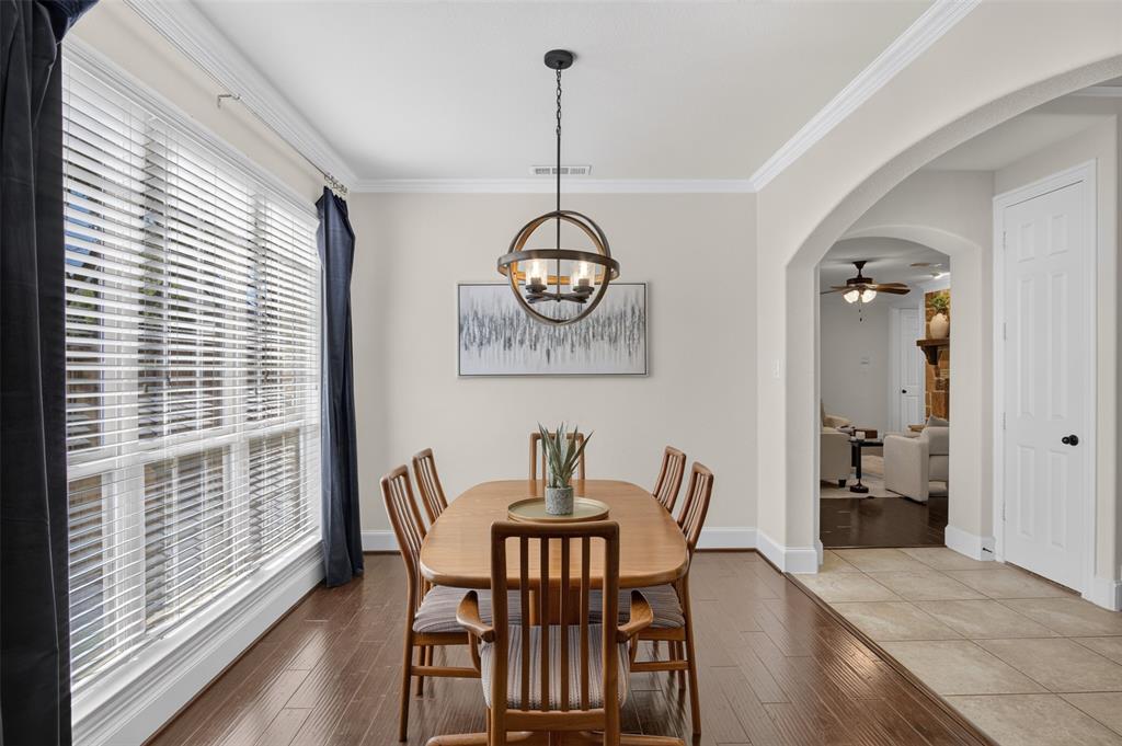842 Sun Meadow Road Allen, TX 75013 - Photo 13 of 39 Dining area featuring wood-finish flooring, a large window with white blinds, and crown molding