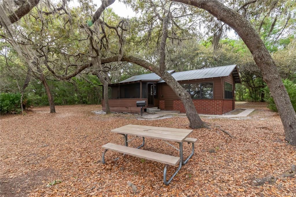 22645 Northeast 105th Avenue Road Fort McCoy, FL 32134 - Photo 18 of 27 a view of a house with backyard and a sitting area