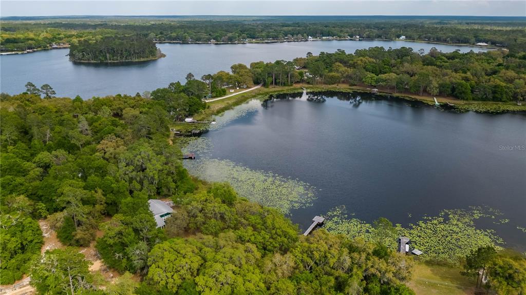22645 Northeast 105th Avenue Road Fort McCoy, FL 32134 - Photo 21 of 27 an aerial view of a houses with a lake view