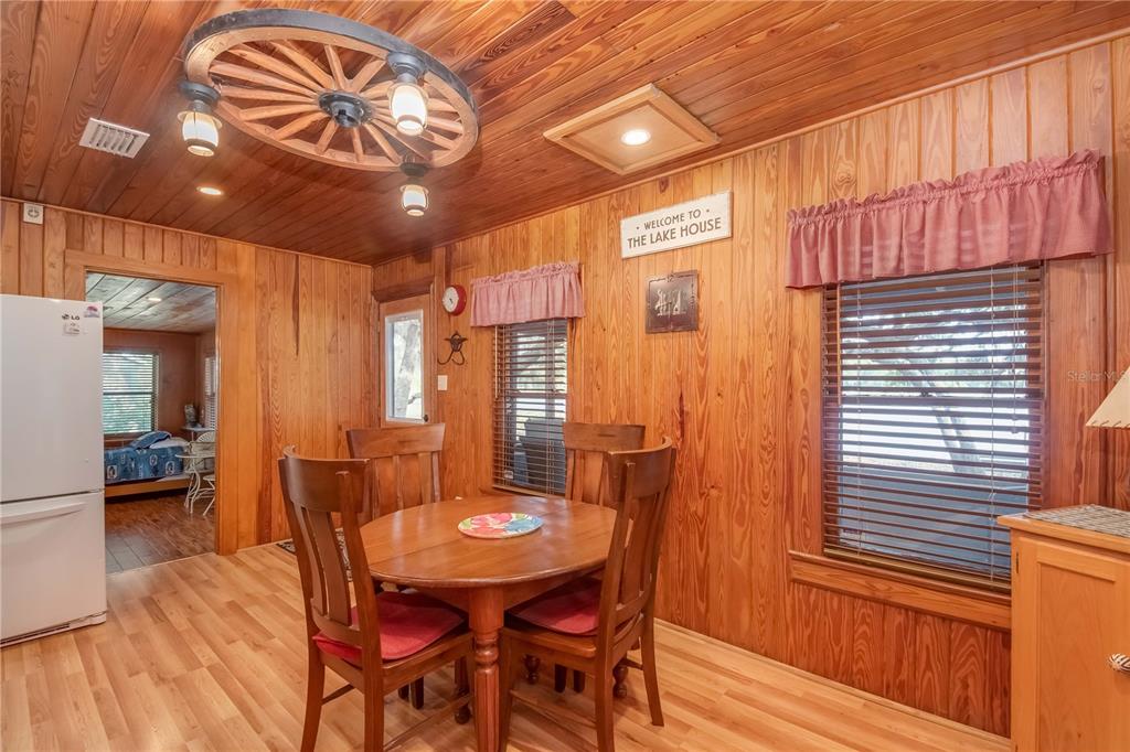 22645 Northeast 105th Avenue Road Fort McCoy, FL 32134 - Photo 9 of 27 a dining room with furniture and wooden floor