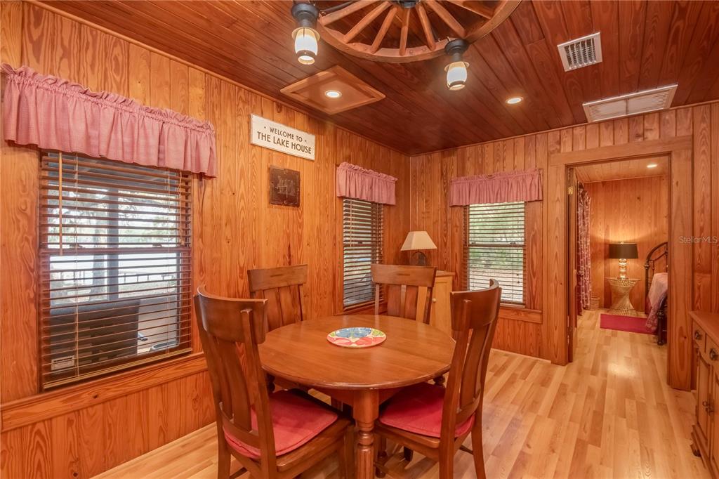 22645 Northeast 105th Avenue Road Fort McCoy, FL 32134 - Photo 10 of 27 a view of a dining room with furniture window and wooden floor