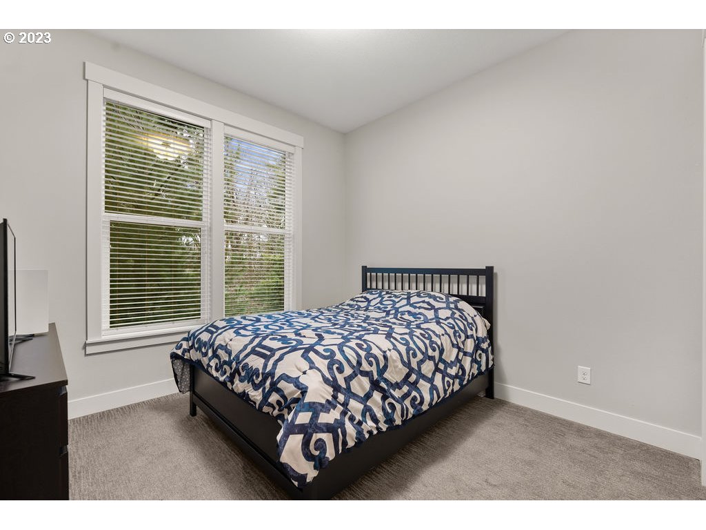 4501 Northwest 122nd Street Vancouver, WA 98685 - Photo 6 of 28 a bed sitting in a bedroom next to a window