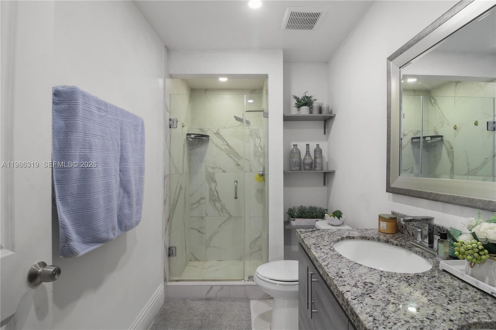 10135 Southwest 139th Place Miami, FL 33186 - Photo 14 of 25 a bathroom with a granite countertop sink toilet and shower