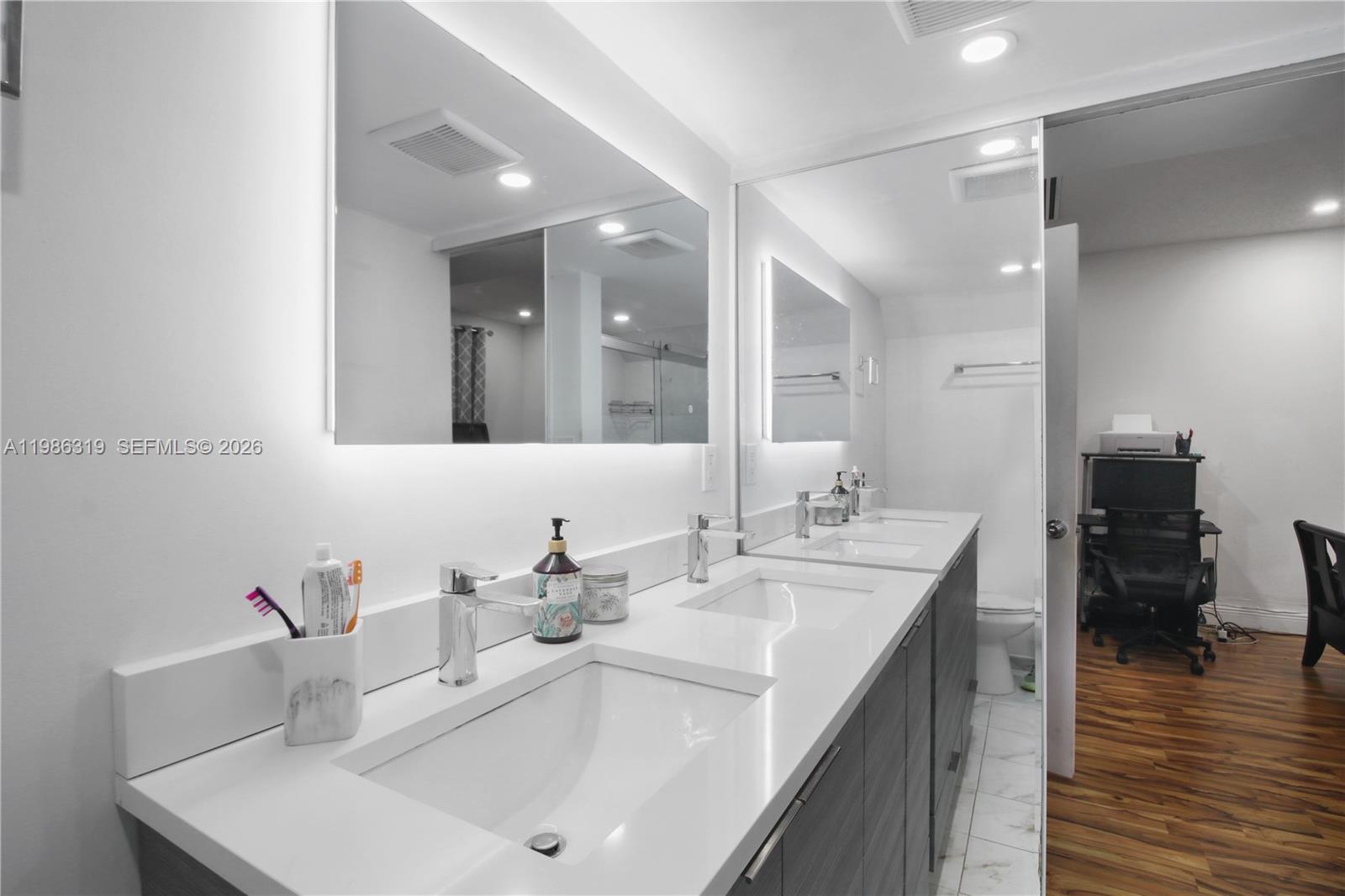10135 Southwest 139th Place Miami, FL 33186 - Photo 17 of 25 a bathroom with a sink and a mirror