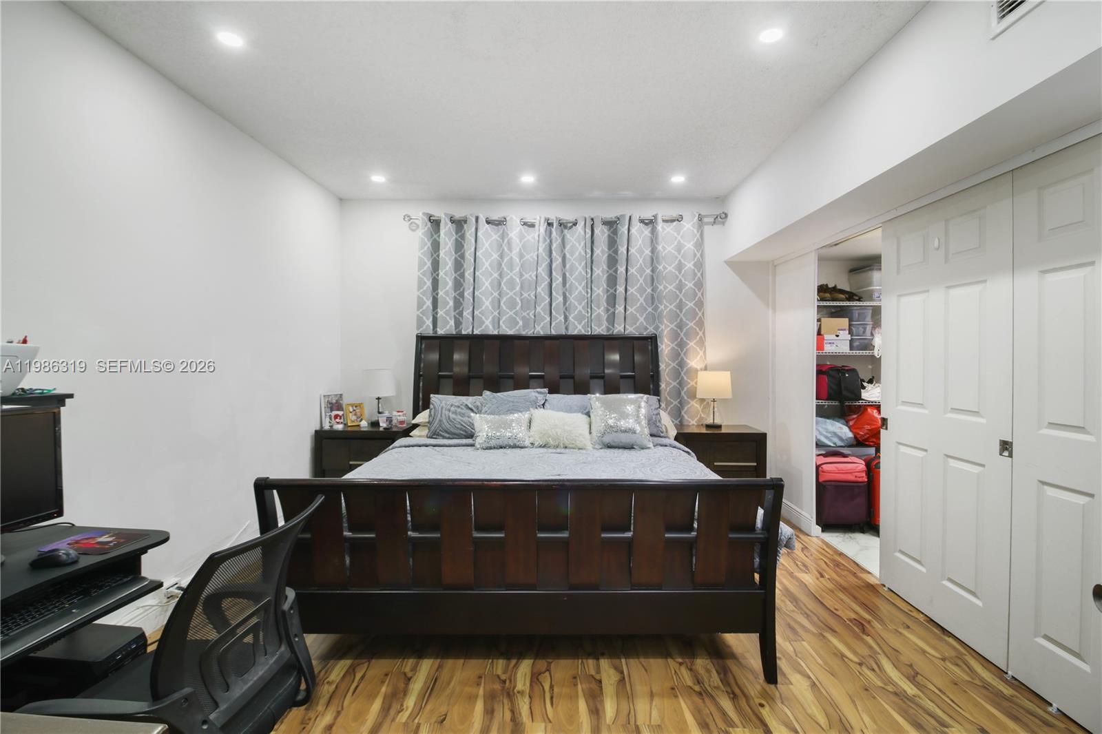 10135 Southwest 139th Place Miami, FL 33186 - Photo 20 of 25 a bed sitting in a room next to a window