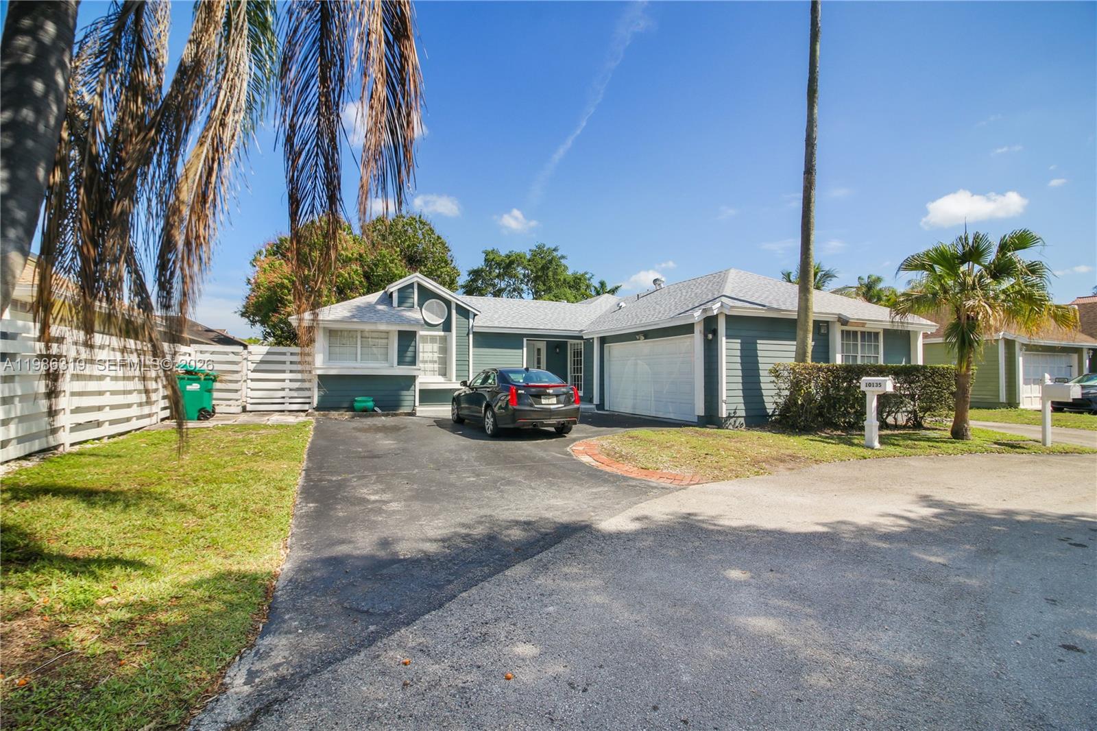 10135 Southwest 139th Place Miami, FL 33186 - Photo 2 of 25 a front view of a house with a yard and garage