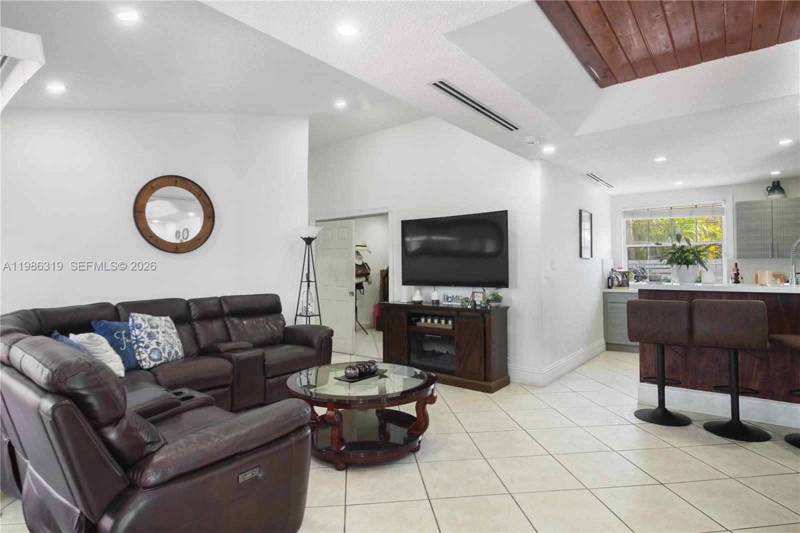 10135 Southwest 139th Place Miami, FL 33186 - Photo 3 of 25 a living room with furniture and a flat screen tv