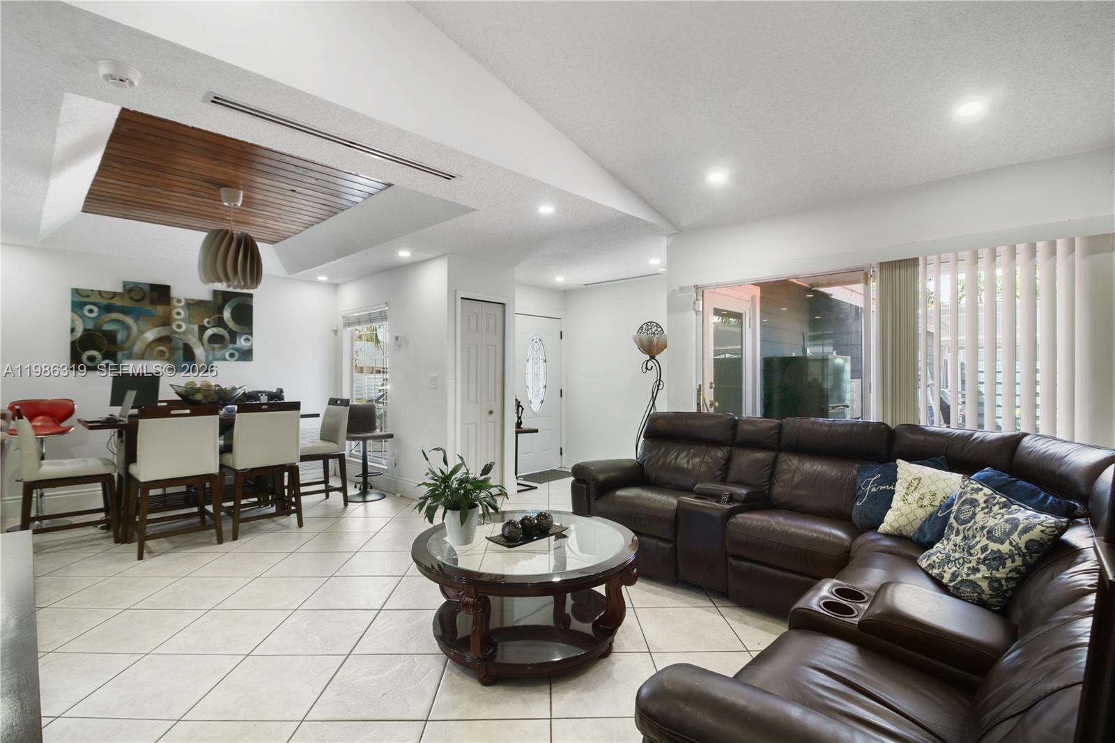 10135 Southwest 139th Place Miami, FL 33186 - Photo 4 of 25 a living room with furniture and a large window