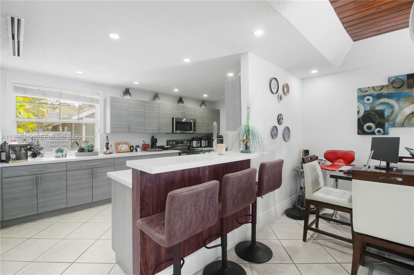 10135 Southwest 139th Place Miami, FL 33186 - Photo 5 of 25 a kitchen with stainless steel appliances kitchen island granite countertop a sink and cabinets