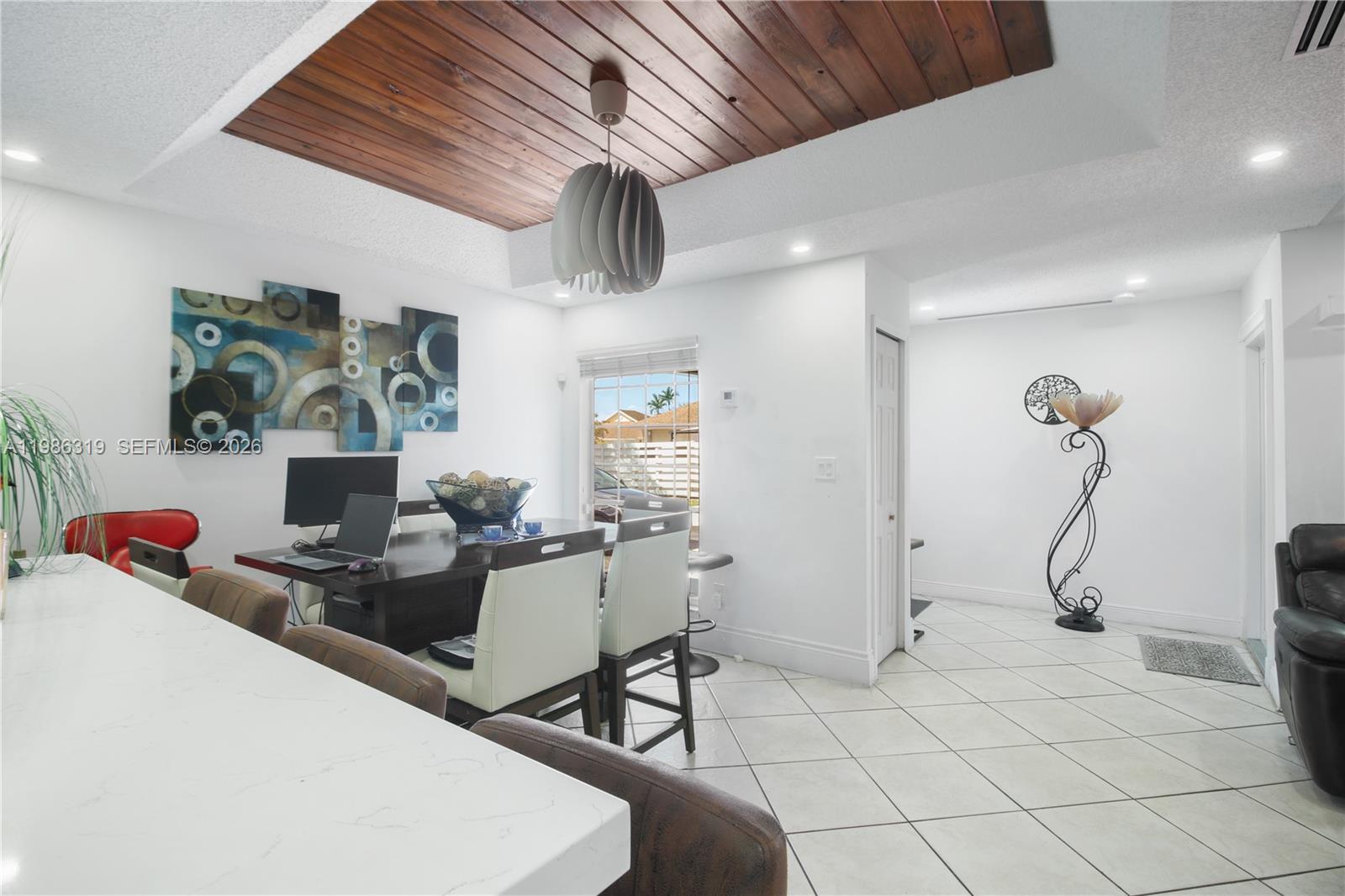 10135 Southwest 139th Place Miami, FL 33186 - Photo 9 of 25 a living room with furniture and a chandelier