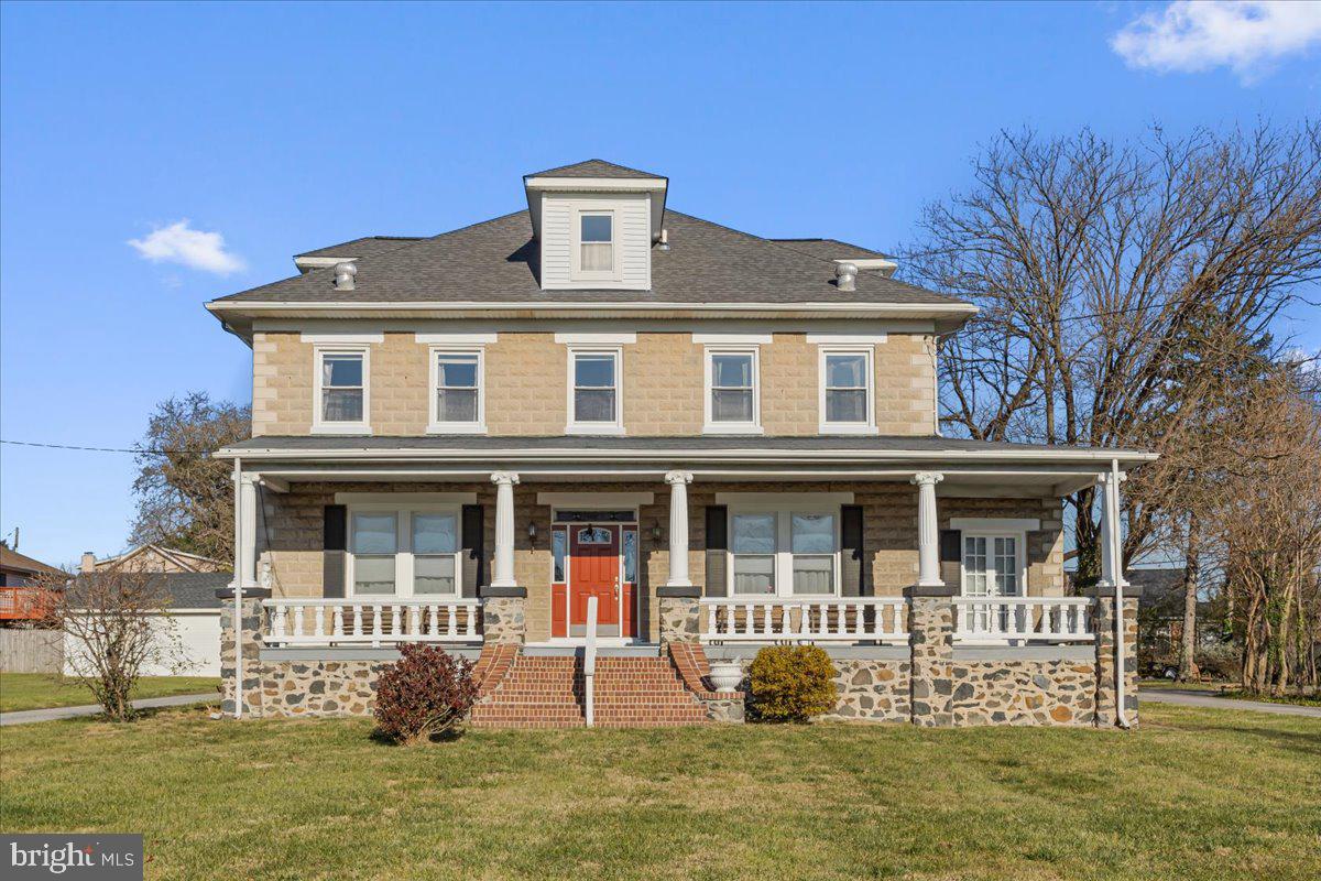 6830 Windsor Mill Road Baltimore, MD 21207 - Photo 1 of 47 a front view of a house with garden