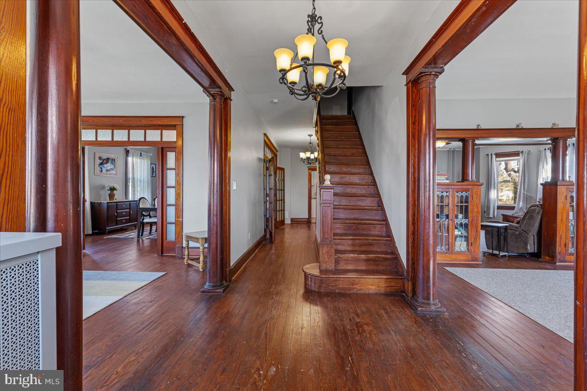 6830 Windsor Mill Road Baltimore, MD 21207 - Photo 6 of 47 a view of a hallway with wooden floor and staircase