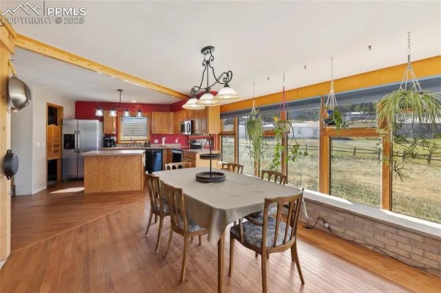 a view of a dining room with furniture window and wooden floor