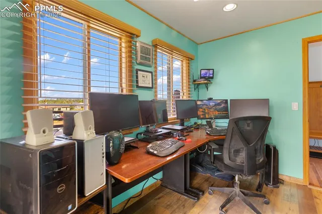 a view of a workspace with furniture and a window