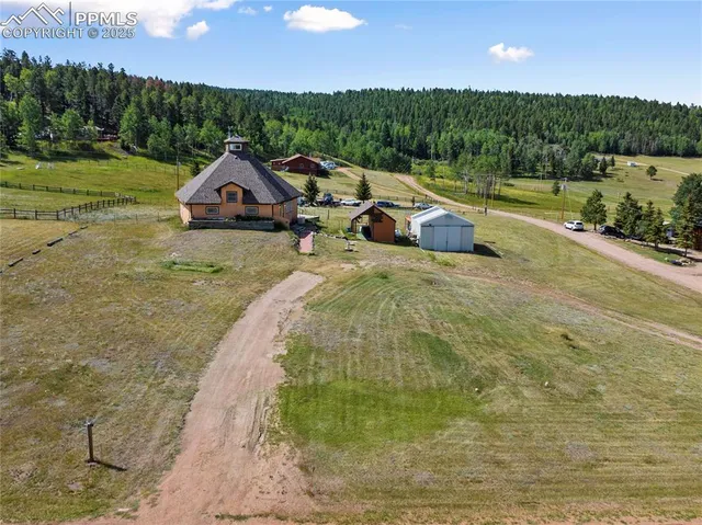 a view of a house with a yard and sitting area