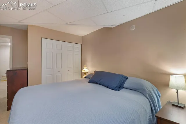 a bedroom with a bed and a night stand