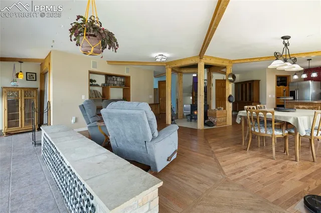 a living room with furniture a dining table and chairs