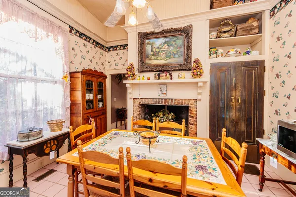 a view of a dining room with furniture and a chandelier