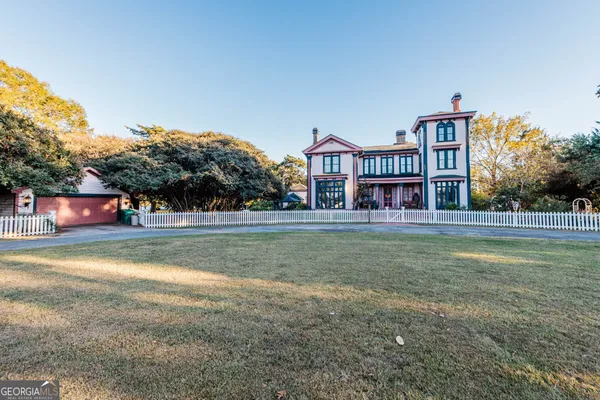 a kitchen with a refrigerator a stove a sink and a dining table