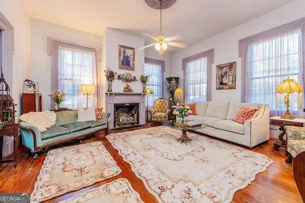 a living room with furniture a rug and a chandelier
