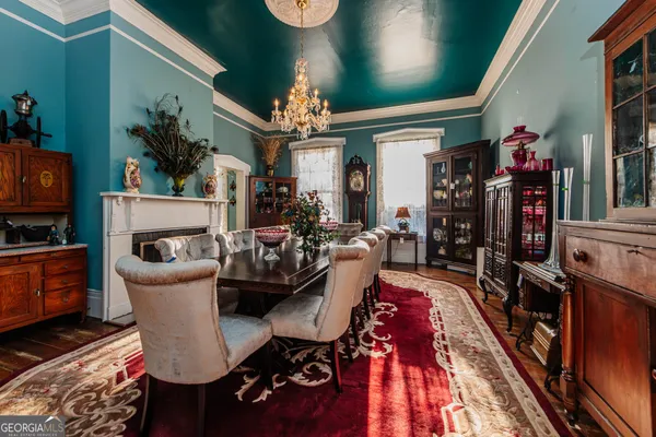 a living room with furniture a large window and a fireplace