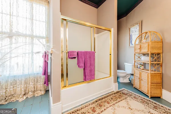 a front view of a house with porch and garden