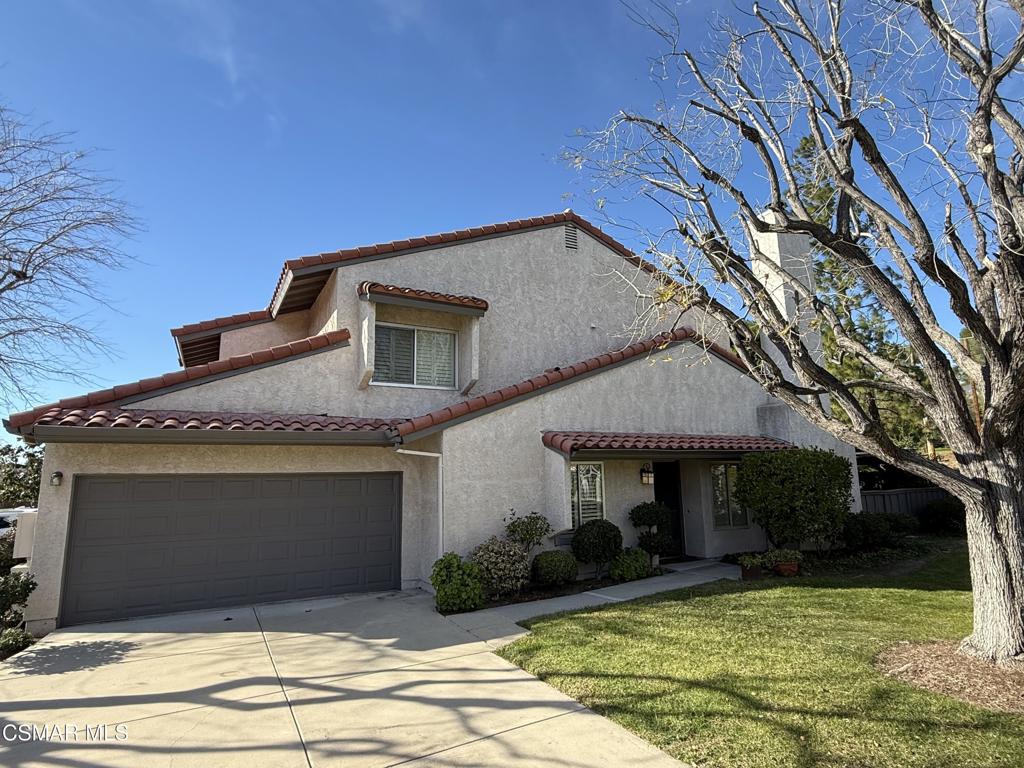 19137 Index Street, Unit 9 Porter Ranch, CA 91326 - Photo 2 of 39 a front view of a house with a yard