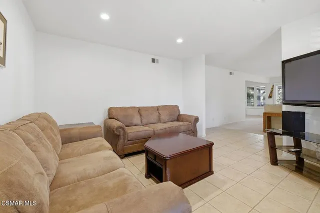 a bedroom with a bed dresser and a window