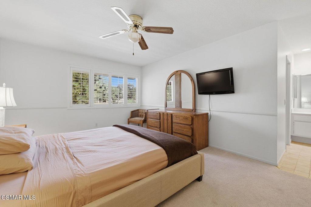 19137 Index Street, Unit 9 Porter Ranch, CA 91326 - Photo 31 of 39 a bedroom with a bed a flat screen tv and a window