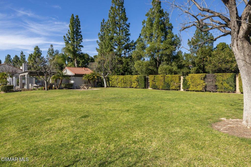 19137 Index Street, Unit 9 Porter Ranch, CA 91326 - Photo 34 of 39 a view of a garden with a bench