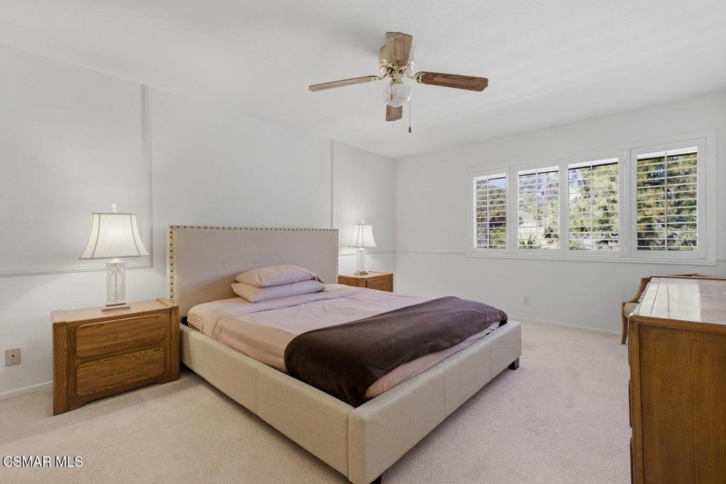 19137 Index Street, Unit 9 Porter Ranch, CA 91326 - Photo 38 of 39 a bedroom with a bed lamp on table and a window
