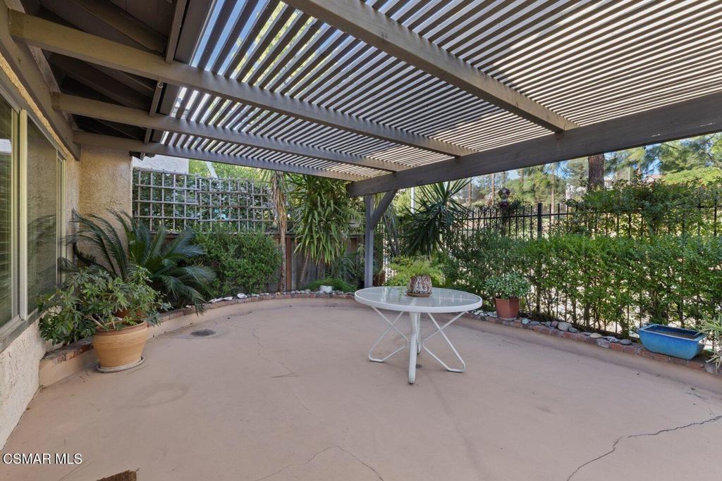 19137 Index Street, Unit 9 Porter Ranch, CA 91326 - Photo 5 of 39 a roof deck with table and chairs and potted plants