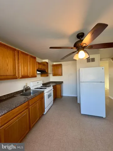 a kitchen with stainless steel appliances granite countertop a sink and cabinets