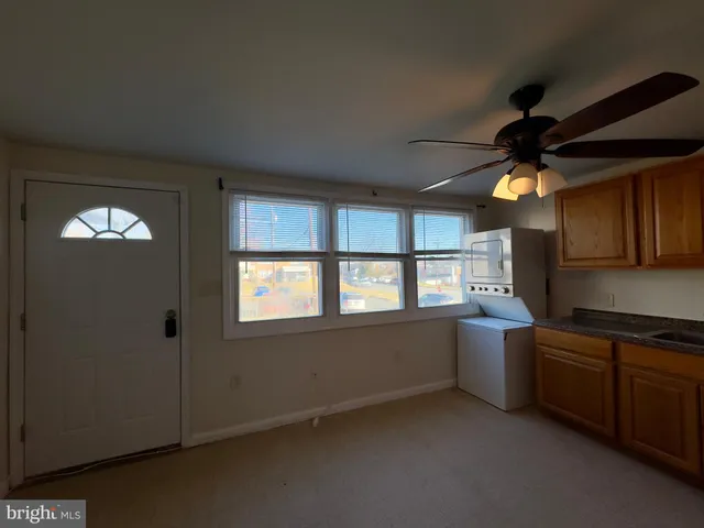 a kitchen with granite countertop a stove and a sink