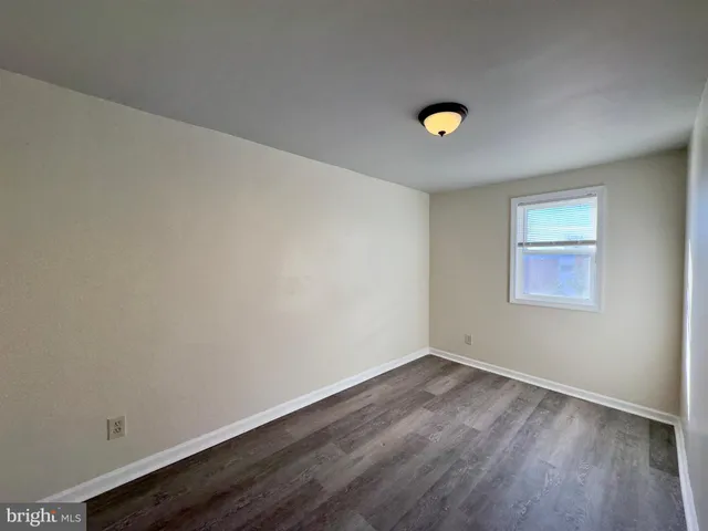 a view of a room with wooden floor and a sink