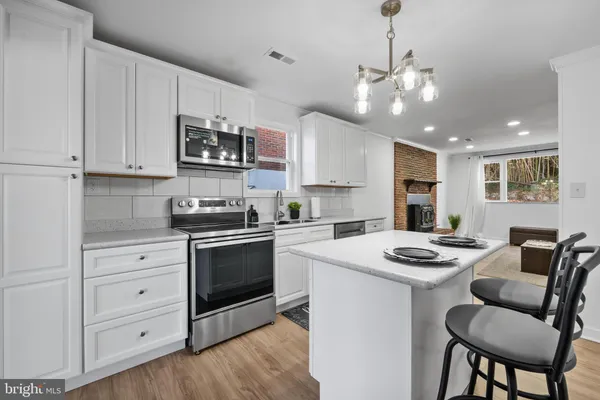 a kitchen with a white table chairs and a stove