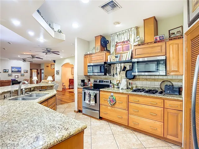 a kitchen with stainless steel appliances granite countertop a sink and cabinets