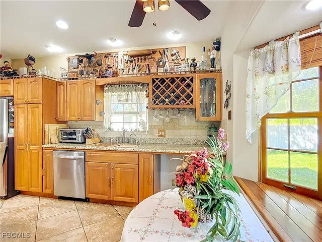 a kitchen with stainless steel appliances kitchen island granite countertop a sink and cabinets