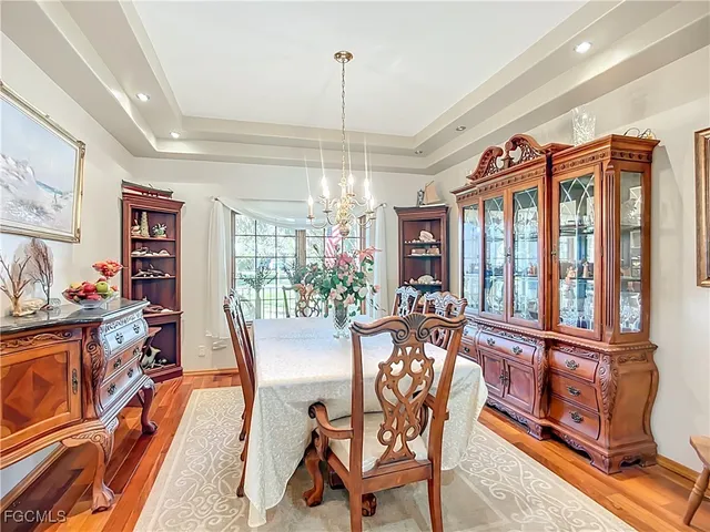 a dining room with furniture a chandelier and window